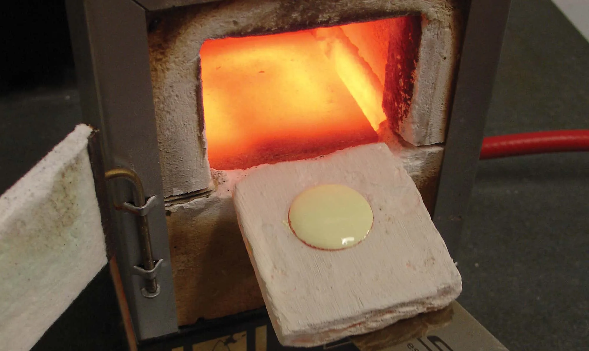 Firing an enamel painting in the kiln at 750°C